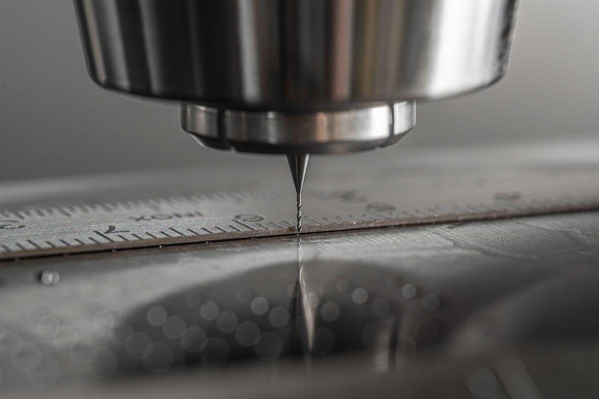 Micro end mill positioned over a steel rule